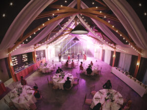 a group of people in a room with tables and chairs